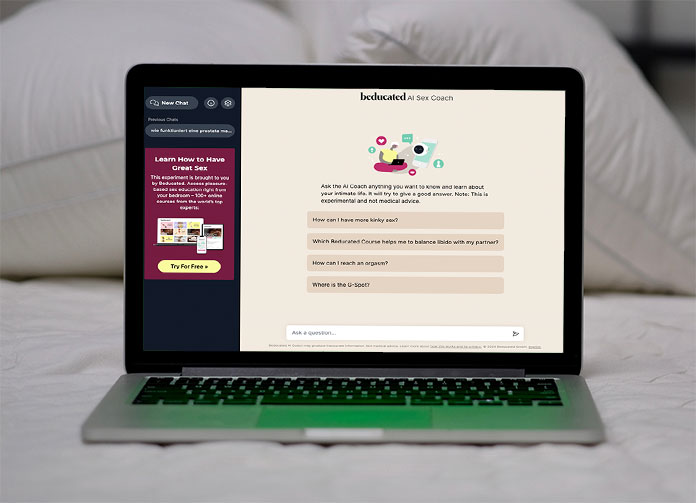 Beducated auf Laptop der auf einem Bett steht